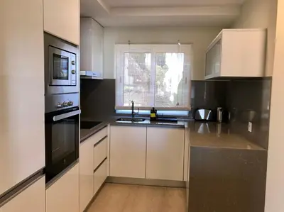 a kitchen with a sink and a microwave at São Rafael Beach Apartment in Albufeira