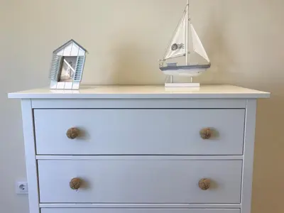 a dresser with two toy boats on top of it at São Rafael Beach Apartment in Albufeira