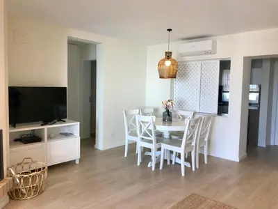 a kitchen and dining room with a table and chairs at São Rafael Beach Apartment in Albufeira