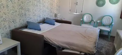 a bedroom with a bed with a laptop on it at Irene's Place Marina in Quarteira