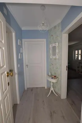 a blue room with a white door and a sink at Irene's Place Marina in Quarteira