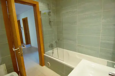 a bathroom with a bath tub and a sink at Vilamoura Condominio do Pinhal in Vilamoura