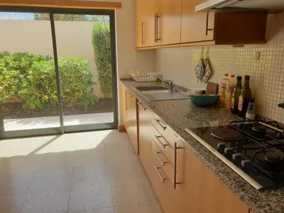 a kitchen with a stove and a sink and a window at Albufeira Oura Beach V4 Villa Marisa with private Pool in Albufeira
