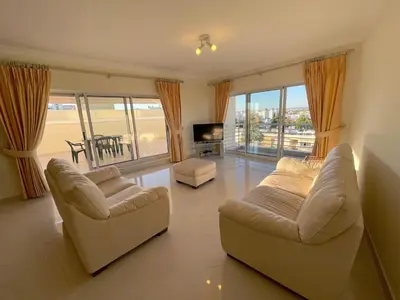 a bedroom with a large bed and a window at MouraPraia By Garvetur in Vilamoura