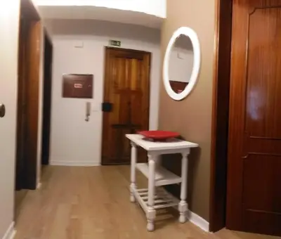 a room with a stool with a mirror and a door at Casa dos Teixeiras in Quarteira