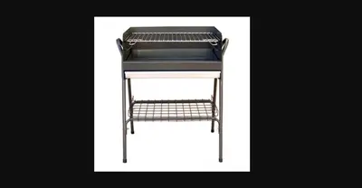 a grill with a black top on a white background at Casa dos Teixeiras in Quarteira
