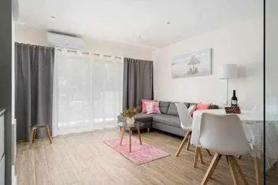 a living room with a couch and a table at Vilamoura new style apt piscina wifi in Vilamoura