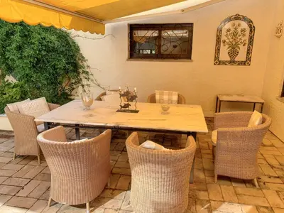a wooden table and chairs in a patio at Elegant Villa in Vilamoura with Private Pool in Vilamoura