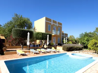 a shower with a glass door and a window at Delightful, authentic Quinta with pool in Loulé