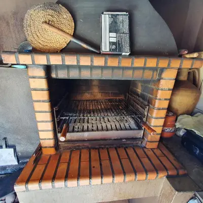 a brick oven with a basket on top of it at Quinta das Nespereiras in Patã de Cima