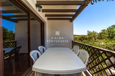 a white table and chairs on a balcony at D'Alma Falésia Beach Apartment - By Dalma Portuguesa in Albufeira