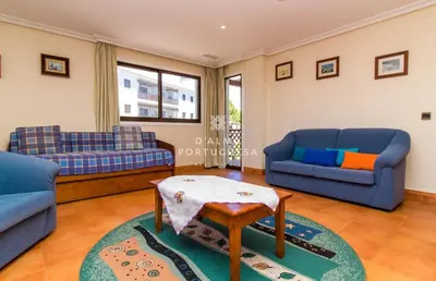 a living room with blue couches and a table at D'Alma Falésia Beach Apartment - By Dalma Portuguesa in Albufeira