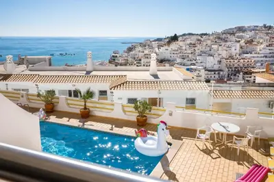 a view from the balcony of a villa with a swimming pool at Apartamentos Mónaco by Garvetur in Albufeira