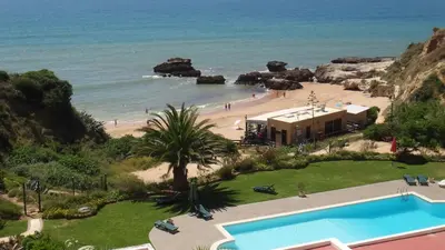 a resort with a swimming pool and a beach at CASA OKSANA in Albufeira