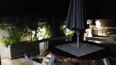 a table and an umbrella on a patio at CASA OKSANA in Albufeira