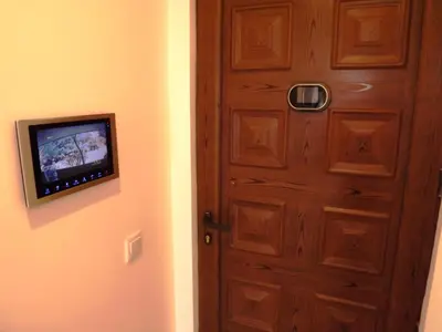 a door with a tv on the wall next to it at CASA OKSANA in Albufeira