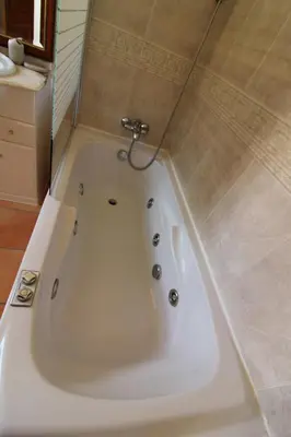a large white bath tub in a bathroom at Villa Martina - São Rafael - Albufeira in Albufeira