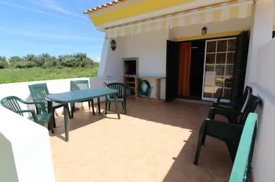 a patio with a table and chairs on a balcony at Villa Martina - São Rafael - Albufeira in Albufeira