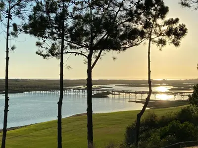 a large pool of water with chairs and trees at Victory Village, Quinta do lago in Almancil