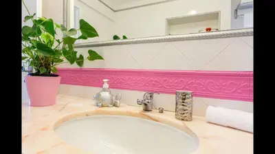 a bathroom with a sink and a pink wall at Apartment in Vilamoura (Marina) in Vilamoura