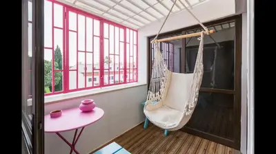 a porch with a hammock and a table and window at Apartment in Vilamoura (Marina) in Vilamoura