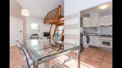 a glass table in the middle of a kitchen at Apartment in Vilamoura (Marina) in Vilamoura