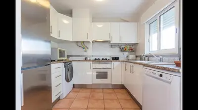 a white kitchen with white cabinets and appliances at Apartment in Vilamoura (Marina) in Vilamoura