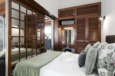 a bedroom with a white bed with wooden walls at Marina Club - Sea front - Vilamoura in Vilamoura