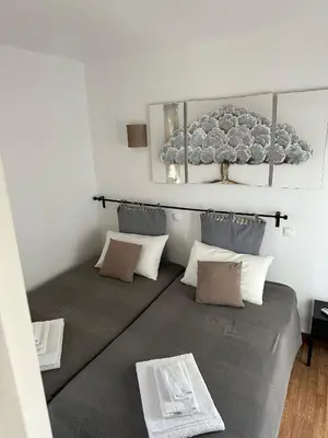 a room with a large bed with pillows at Duplex Marina de Vilamoura in Vilamoura