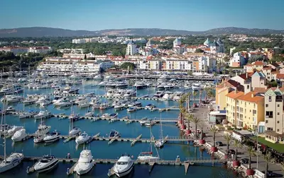 a harbor filled with lots of boats in a city at Duplex Marina de Vilamoura in Vilamoura