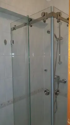 a shower with a glass door in a bathroom at Quarteira Beach in Quarteira