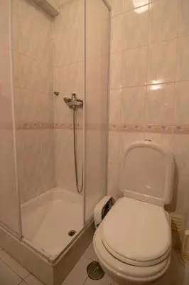a bathroom with a toilet and a shower at Quarteira Beach in Quarteira