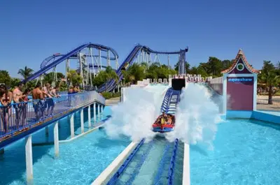 a roller coaster in a water park with a rollercoaster at Quarteira Beach in Quarteira