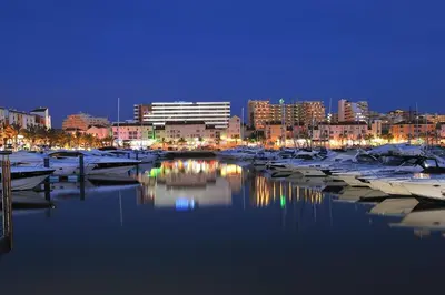 a group of boats docked in a harbor at night at Lotus Villa V5 com piscina comum - Boliqueime, Algarve in Boliqueime