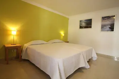 a bedroom with a white bed and two lamps at Lotus Villa V5 com piscina comum - Boliqueime, Algarve in Boliqueime