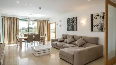 a living room with a couch and a table at Marina Vilamoura Aquamar 220 By Vilamoura Sun in Quarteira