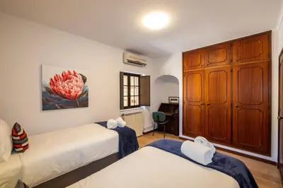 a bedroom with two beds and a cabinet at Casa Katarina - Private Villa - Heated pool - Free Wifi - Air Con in Tunes
