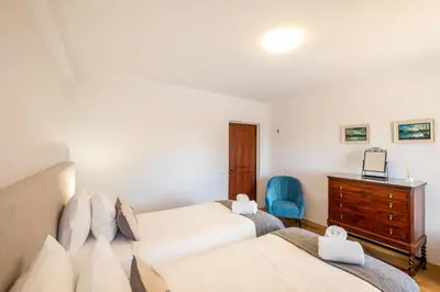 a bedroom with two beds and a wooden dresser at Casa Katarina - Private Villa - Heated pool - Free Wifi - Air Con in Tunes