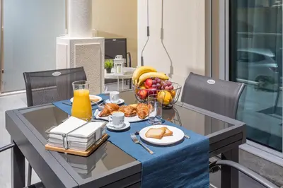 a table with a bowl of fruit and a plate of food at D_Loft Ocean in Albufeira