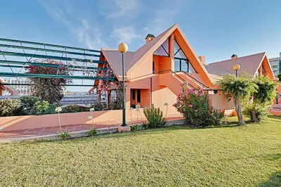 a house in front of a large building at Marina Princess in Vilamoura