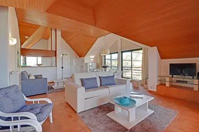 a living room with a couch and a tv at Marina Princess in Vilamoura