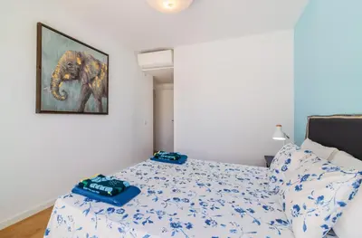 a bedroom with a bed and a picture of an elephant at Garden Design in Albufeira