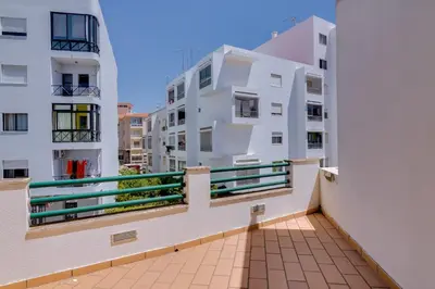 a balcony with a view of two buildings at Casa Luz - Quarteira in Quarteira