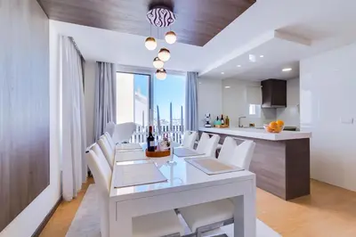 a dining room with a white table and white chairs at Gold II - Luxurious apartment - Vilamoura in Vilamoura