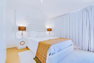 a white bedroom with a bed and a window at Gold II - Luxurious apartment - Vilamoura in Vilamoura