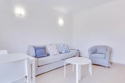 a living room with a couch and a chair and a table at Tália I - City Center - Vilamoura in Vilamoura