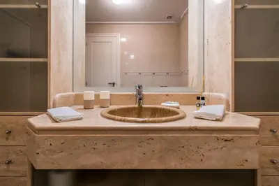 a bathroom with a sink and a mirror at CAROB APARTMENT - BY MAYORAL (FALÉSIA BEACH) in Olhos de Água