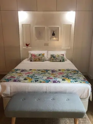 a bedroom with a bed with a bench in it at Porta 20 in Loulé