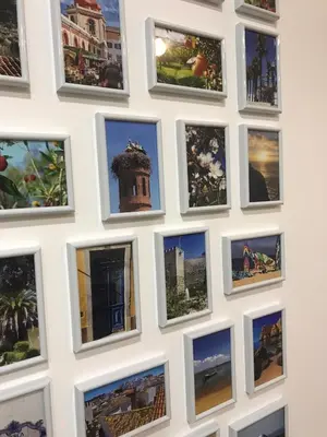 a wall of photos of monuments and buildings at Porta 20 in Loulé