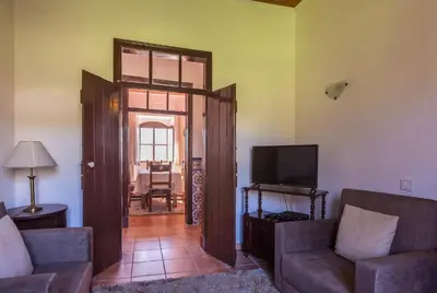 a living room with a couch and a television at Solar da Rosa & Solar da Tirosa in Boliqueime